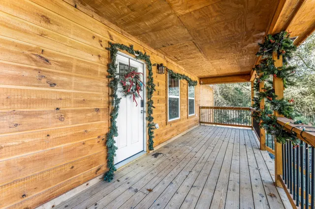 a view of a balcony with wooden floor and fence
