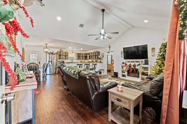 a living room with furniture and a chandelier