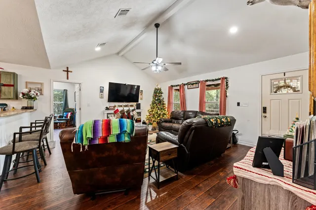 a dining room with furniture and wooden floor