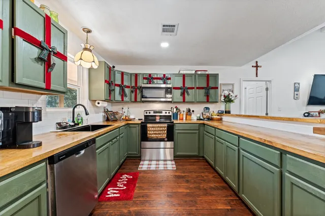 a kitchen with stainless steel appliances granite countertop a sink and cabinets