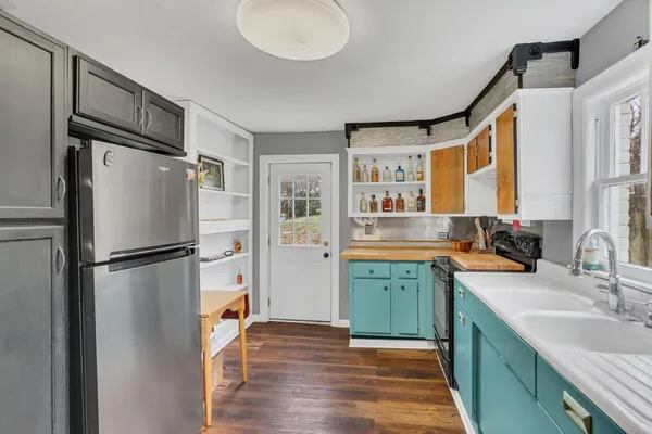 a kitchen with a refrigerator sink and stove