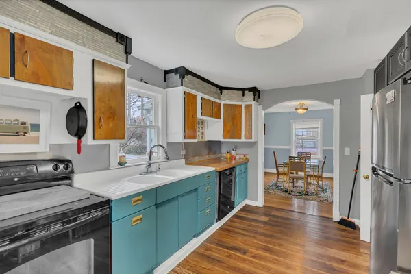 a kitchen with a sink appliances and cabinets