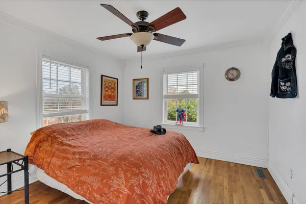 a bed sitting in a bedroom next to a window