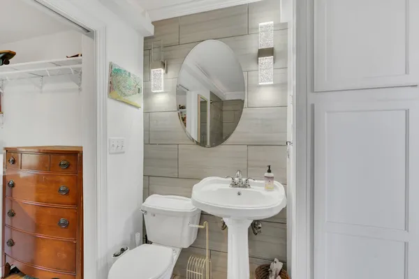 a bathroom with a sink toilet and mirror