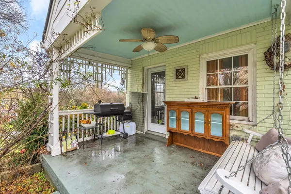 a view of a porch with a table and chairs