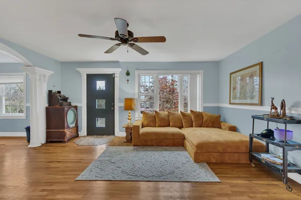 a living room with furniture and a wooden floor