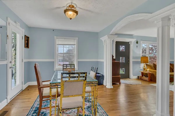 a dining room with furniture and wooden floor