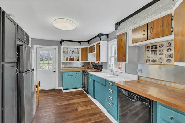 a kitchen with stainless steel appliances granite countertop a refrigerator and a sink