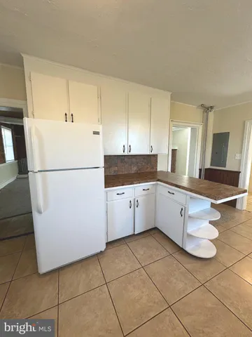 a kitchen with cabinets and white appliances