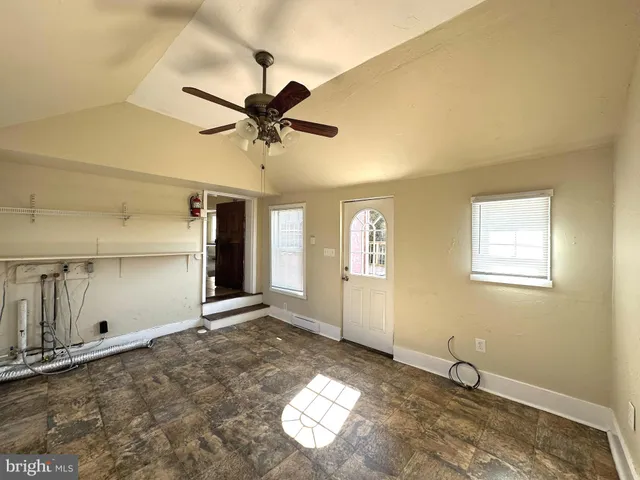 a view of a livingroom with a window and a ceiling fan