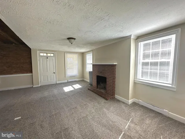 a view of empty room with a fireplace