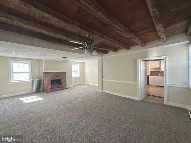 a view of empty room with a fireplace