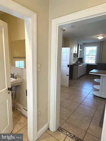 a large en suite bathroom with a toilet a mirror and bathtub