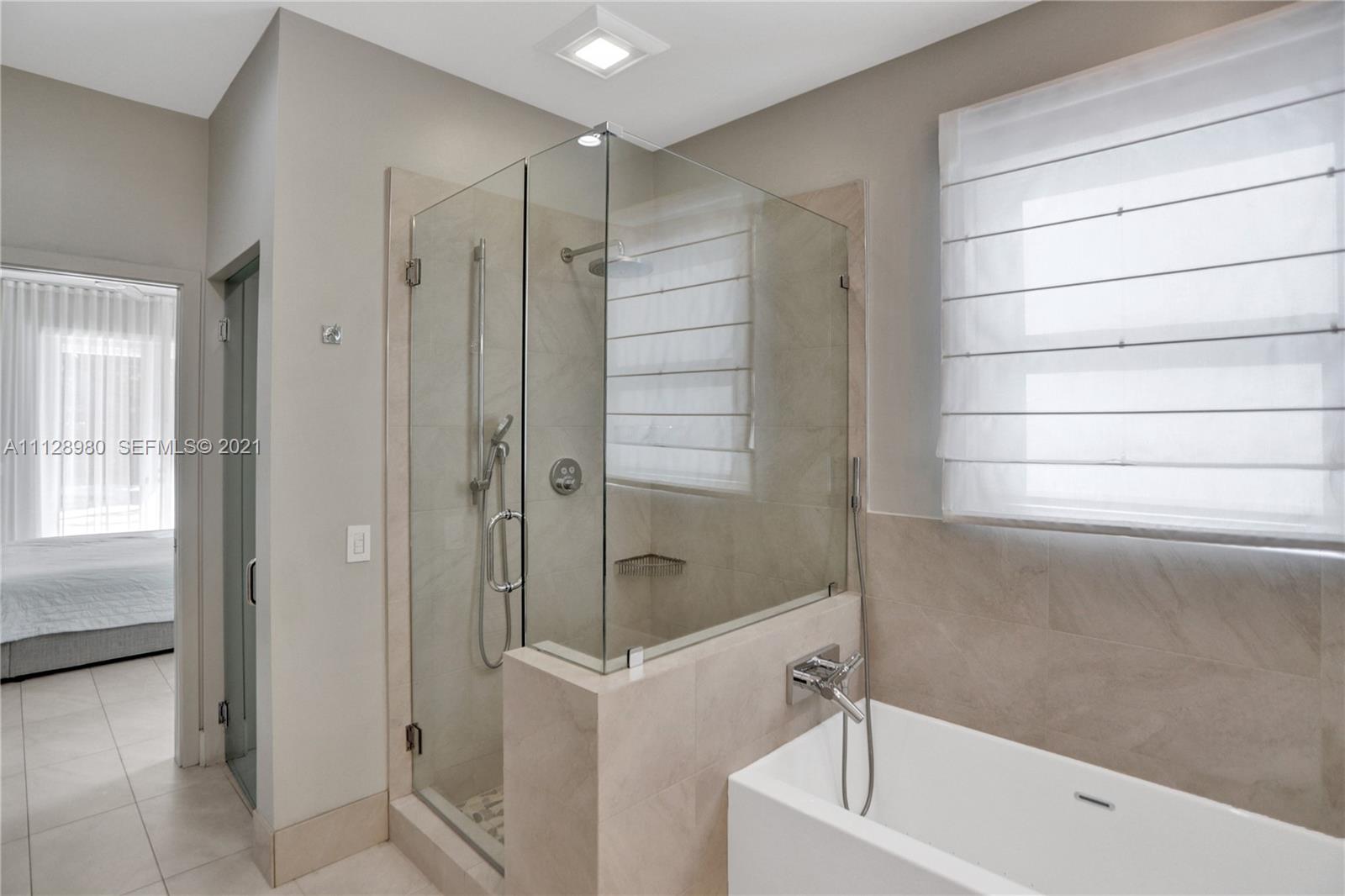 1078 Briar Ridge Road Weston, FL 33327 - Photo 24 of 41 a bathroom with a shower and a tub