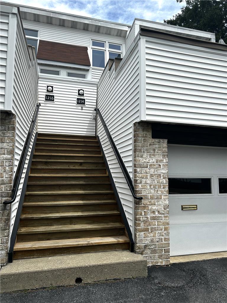 1214 Stanford Road Bethlehem, PA 18018 - Photo 6 of 58 Ascend to your private entry with a garage below, clad in brick and siding.