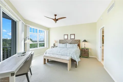 a bedroom with a bed chair and a window