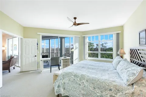 a spacious bedroom with a large bed and a large window