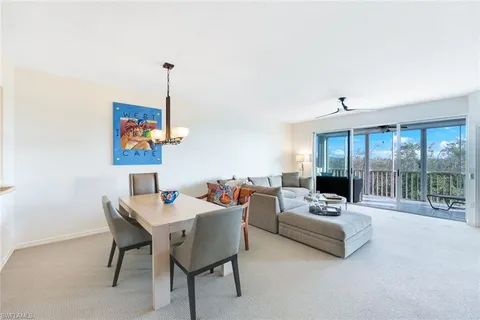 a living room with furniture a couch and a flat screen tv