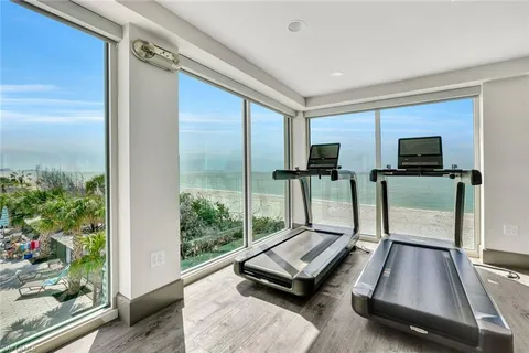 a room with gym equipment and a flat screen tv