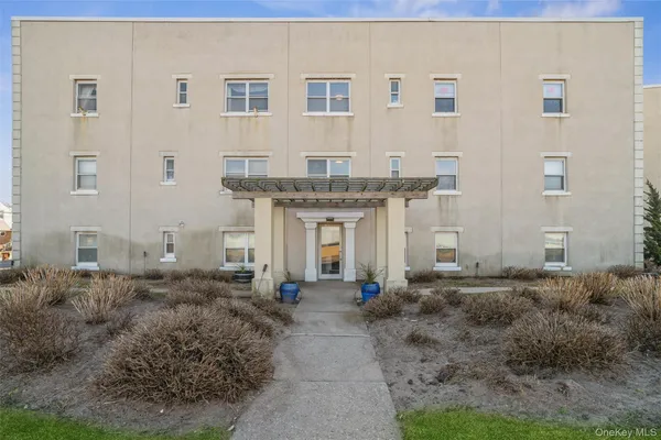 a front view of a building with many windows