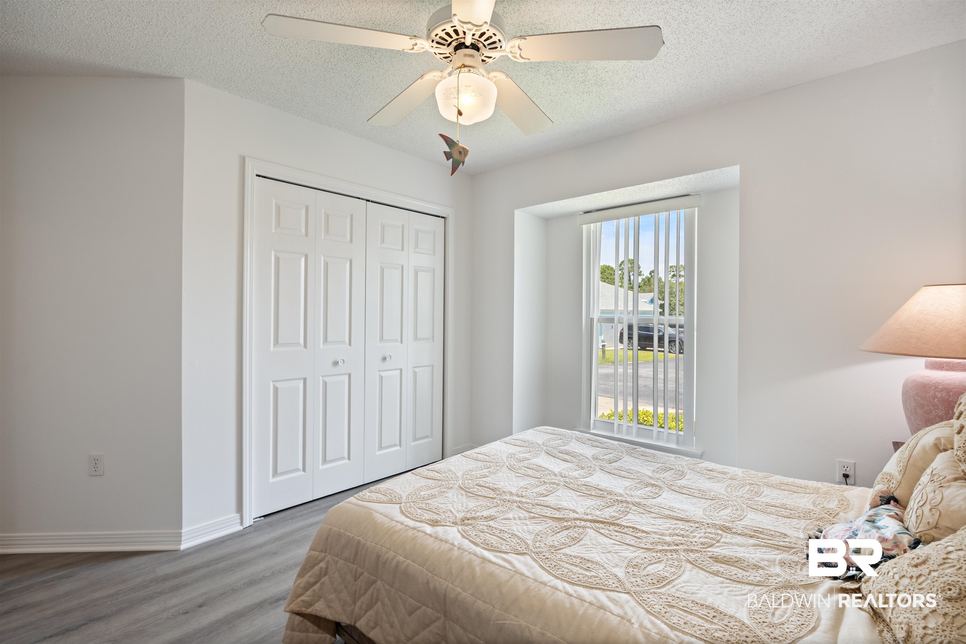 3200 Loop Road, Unit 96 Orange Beach, AL 36561 - Photo 33 of 49 Interior room featuring light gray wood-finish flooring, white walls, and a ceiling fan with integrated lighting
