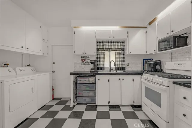 a kitchen with a sink a stove and cabinets
