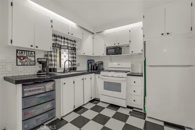 a kitchen with stainless steel appliances a stove a sink and a refrigerator