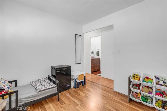 a bedroom with furniture and a wooden floor