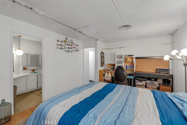 a bed room with a bed and a television