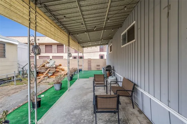 a view of a porch with furniture and a yard