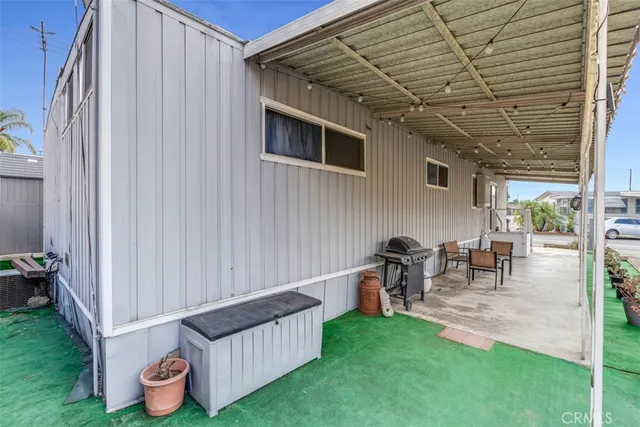a backyard of a house with table and chairs