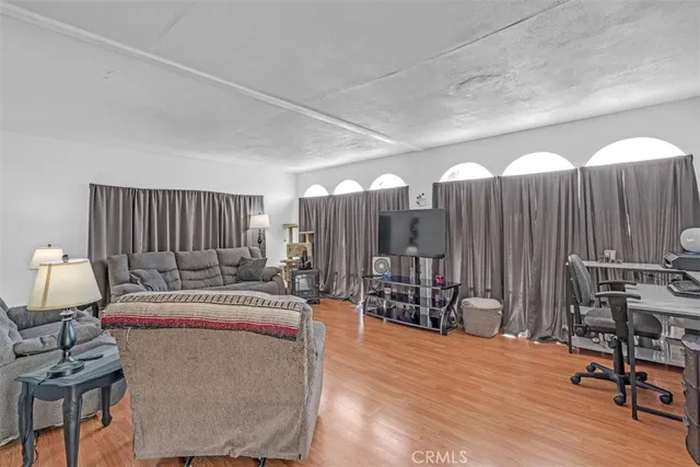 a bedroom with furniture and wooden floor
