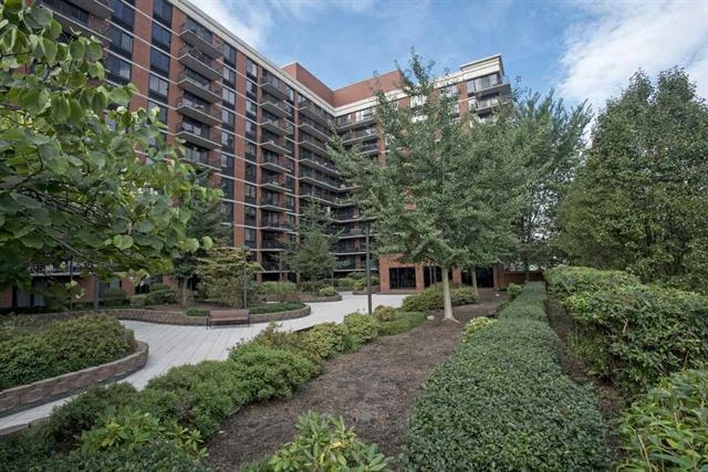 700 Grove Street, Unit 8R Jersey City, NJ 07310 - Photo 11 of 11 a picture of a building with trees