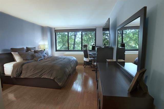 700 Grove Street, Unit 8R Jersey City, NJ 07310 - Photo 4 of 11 a bedroom with a bed and large windows