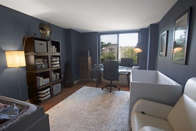 700 Grove Street, Unit 8R Jersey City, NJ 07310 - Photo 5 of 11 a living room with furniture a window and bookshelf