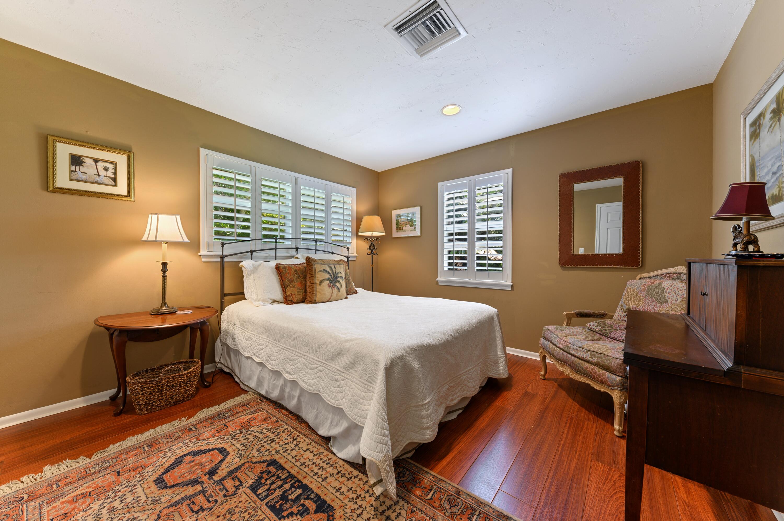 24 Marine Way, Unit 26 Delray Beach, FL 33483 - Photo 11 of 18 a bedroom with a bed and wooden floor