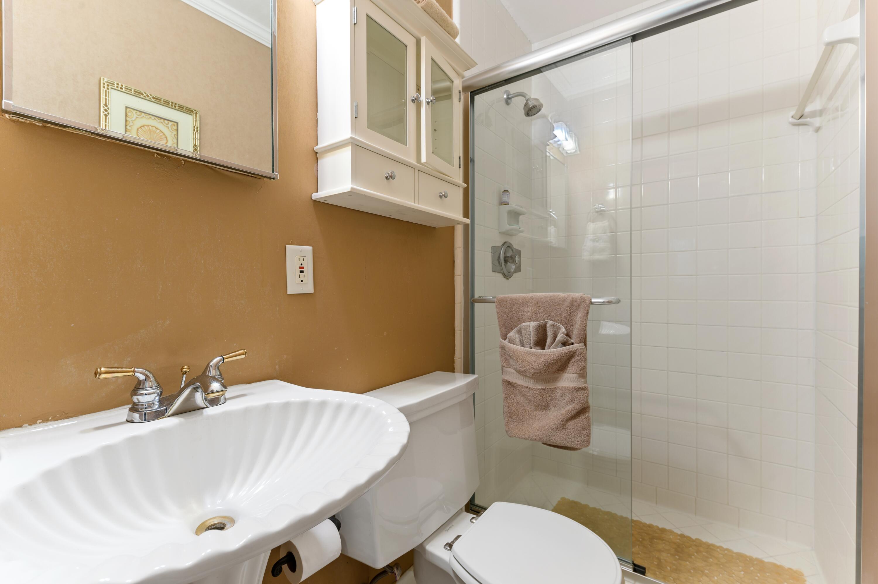 24 Marine Way, Unit 26 Delray Beach, FL 33483 - Photo 12 of 18 a bathroom with a sink a toilet and shower