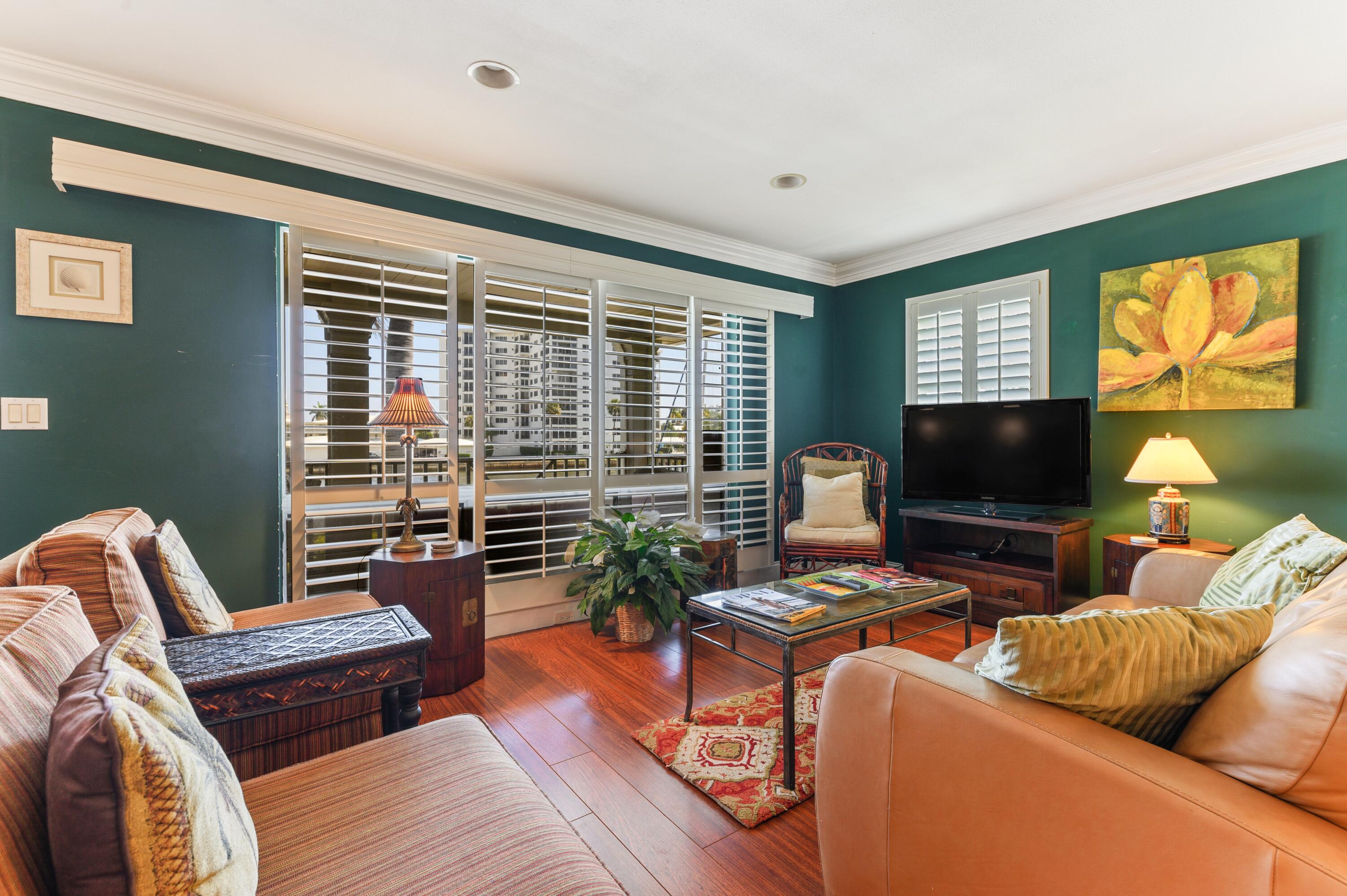 24 Marine Way, Unit 26 Delray Beach, FL 33483 - Photo 3 of 18 a living room with furniture and a flat screen tv