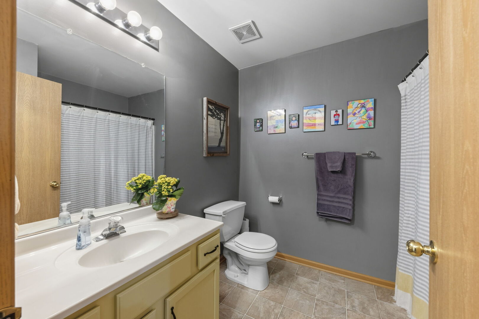 965 Constance Lane, Unit G Sycamore, IL 60178 - Photo 21 of 25 a bathroom with a sink mirror vanity and toilet
