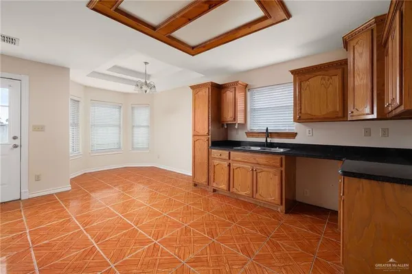 a kitchen with granite countertop a sink cabinets and window