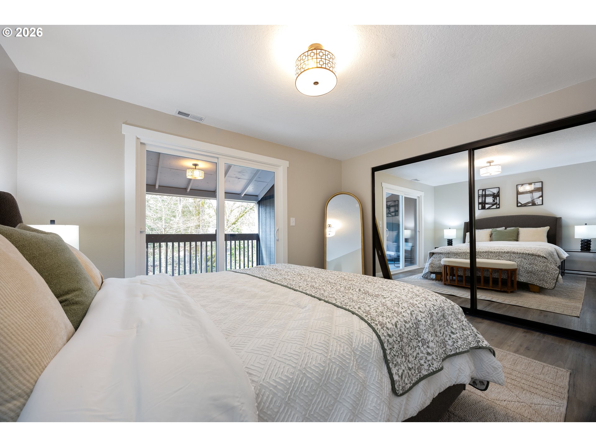 4921 Southwest 59th Avenue, Unit 6 Portland, OR 97221 - Photo 11 of 23 a bedroom with a bed and a large window