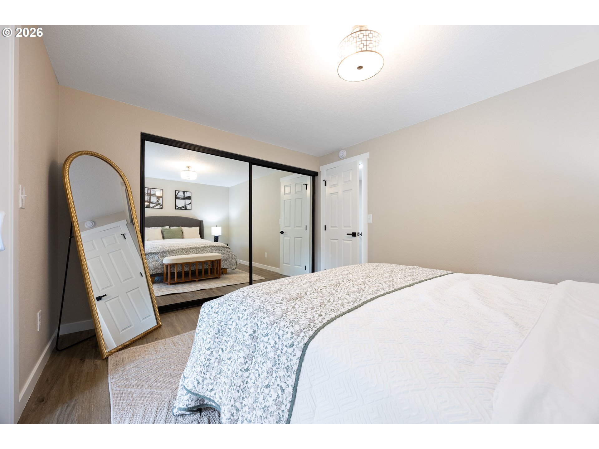 4921 Southwest 59th Avenue, Unit 6 Portland, OR 97221 - Photo 12 of 23 a bedroom with a bed and a large mirror