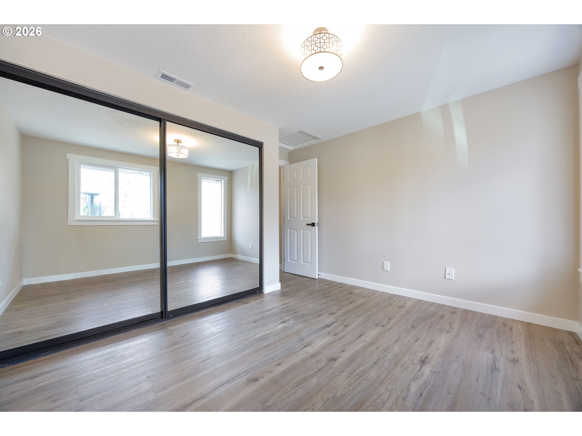 4921 Southwest 59th Avenue, Unit 6 Portland, OR 97221 - Photo 15 of 23 a view of an empty room with wooden floor and a window
