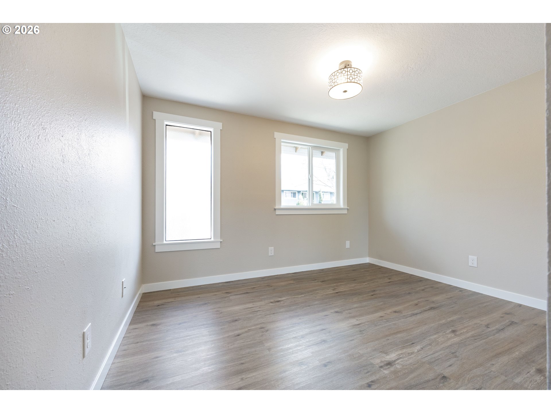 4921 Southwest 59th Avenue, Unit 6 Portland, OR 97221 - Photo 16 of 23 a view of an empty room with wooden floor and a window