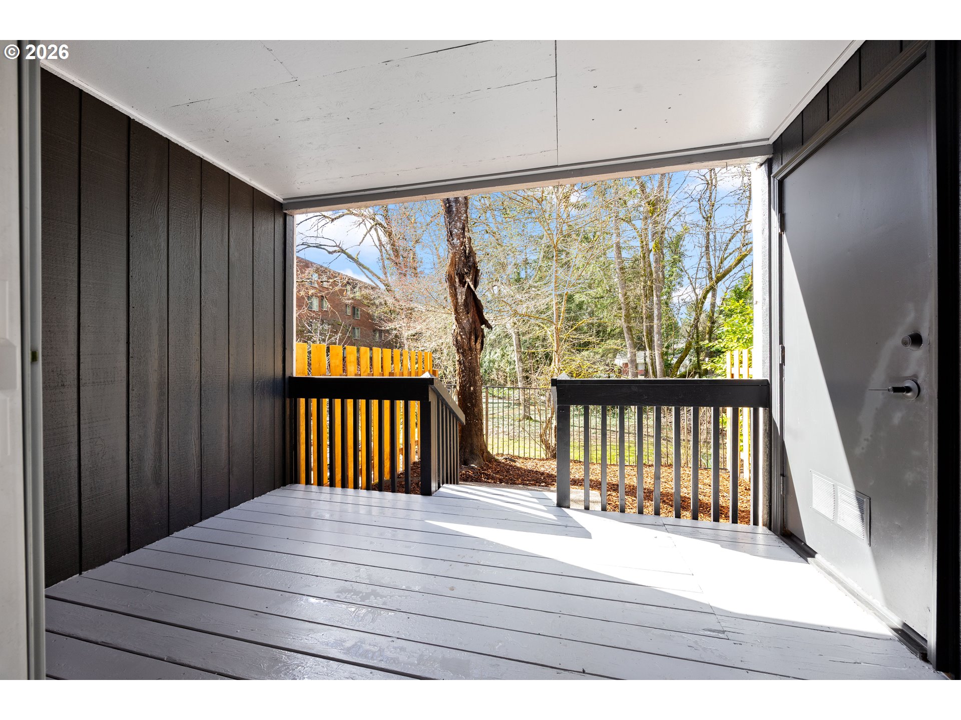 4921 Southwest 59th Avenue, Unit 6 Portland, OR 97221 - Photo 19 of 23 a view of a balcony with wooden floor