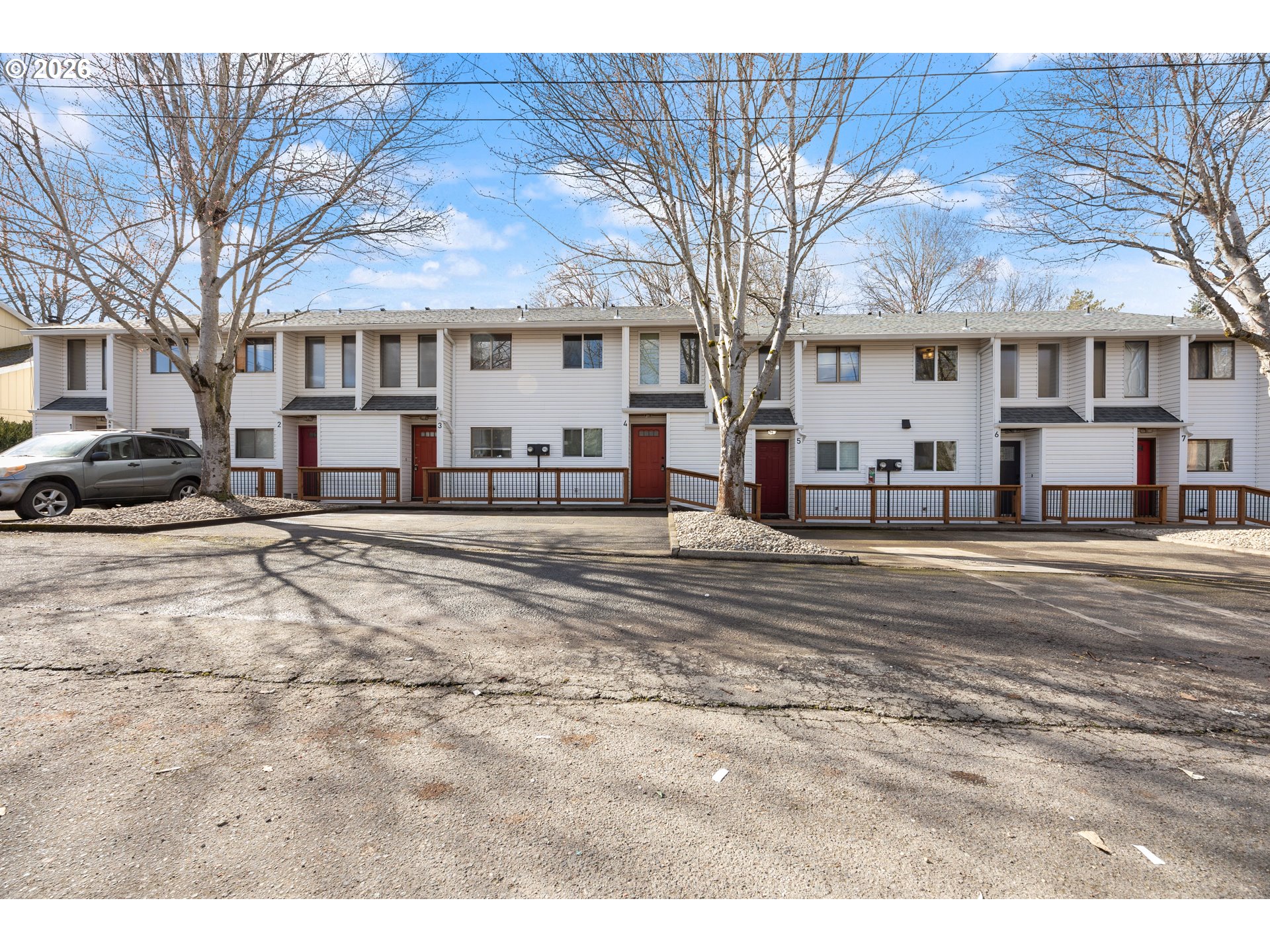 4921 Southwest 59th Avenue, Unit 6 Portland, OR 97221 - Photo 21 of 23 a front view of a building with a yard covered in snow