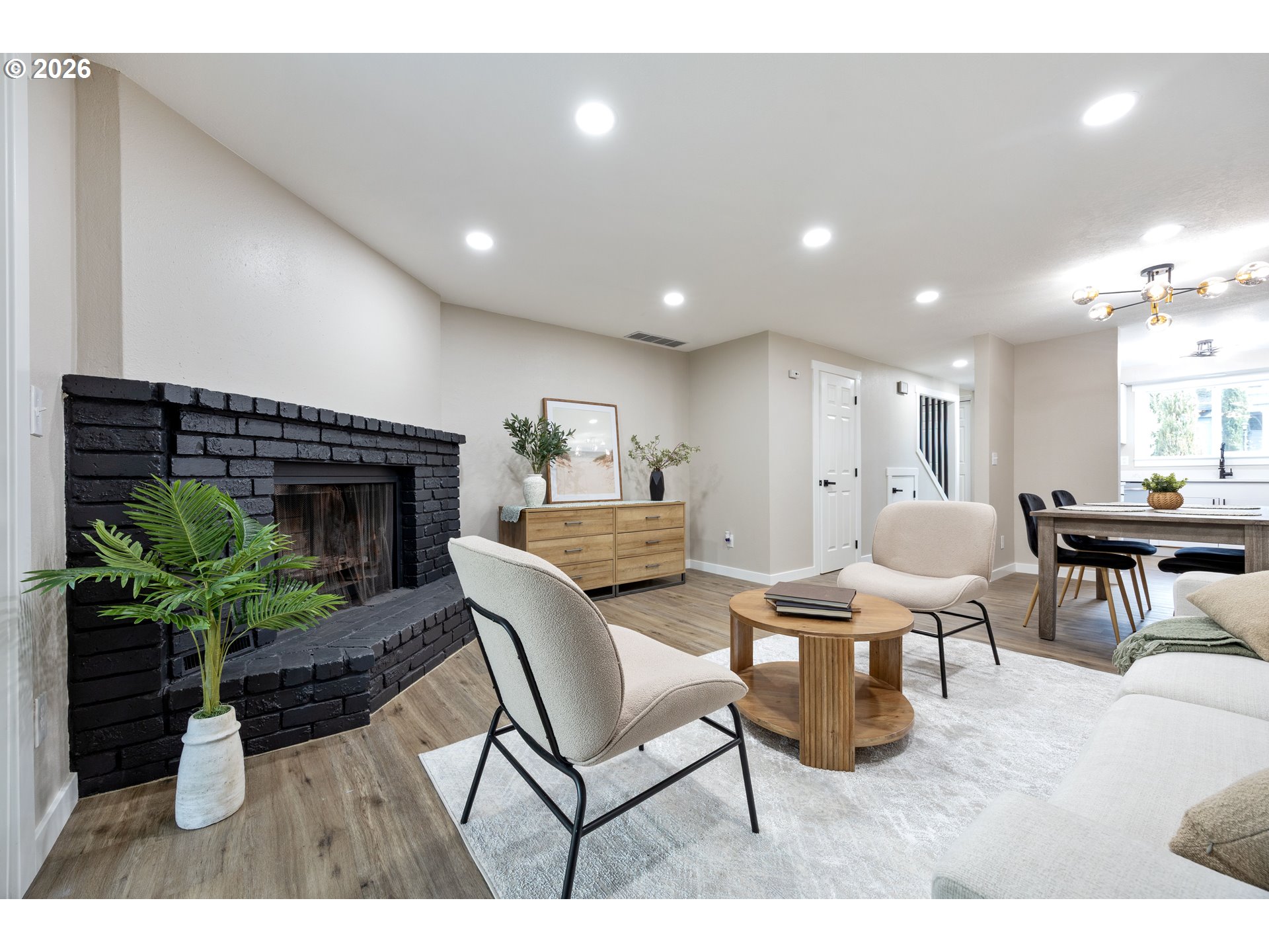 4921 Southwest 59th Avenue, Unit 6 Portland, OR 97221 - Photo 5 of 23 a living room with furniture a fireplace and a potted plant