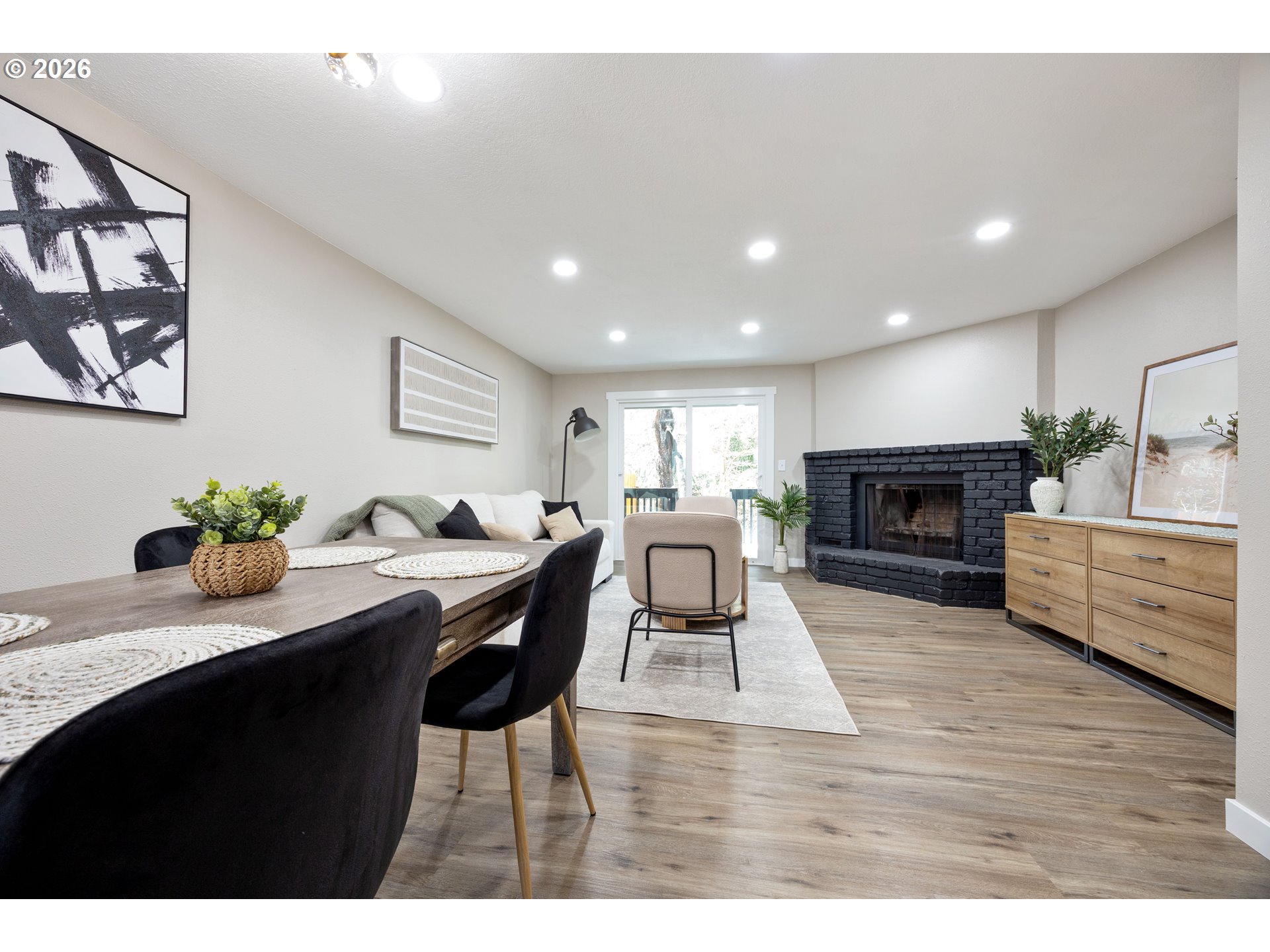 4921 Southwest 59th Avenue, Unit 6 Portland, OR 97221 - Photo 6 of 23 a living room with furniture a fireplace a flat screen tv and a fireplace