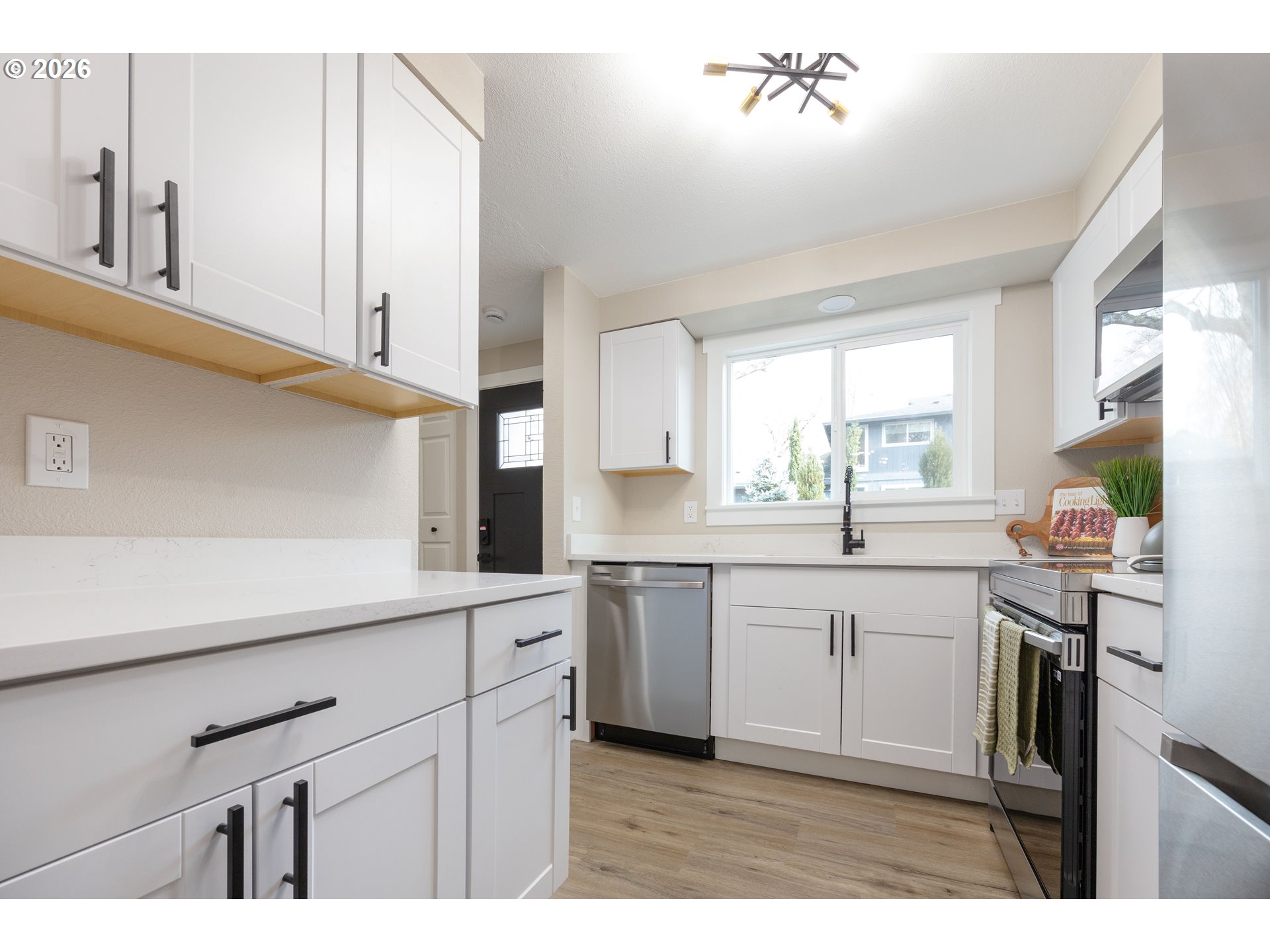 4921 Southwest 59th Avenue, Unit 6 Portland, OR 97221 - Photo 7 of 23 a kitchen with white cabinets and sink