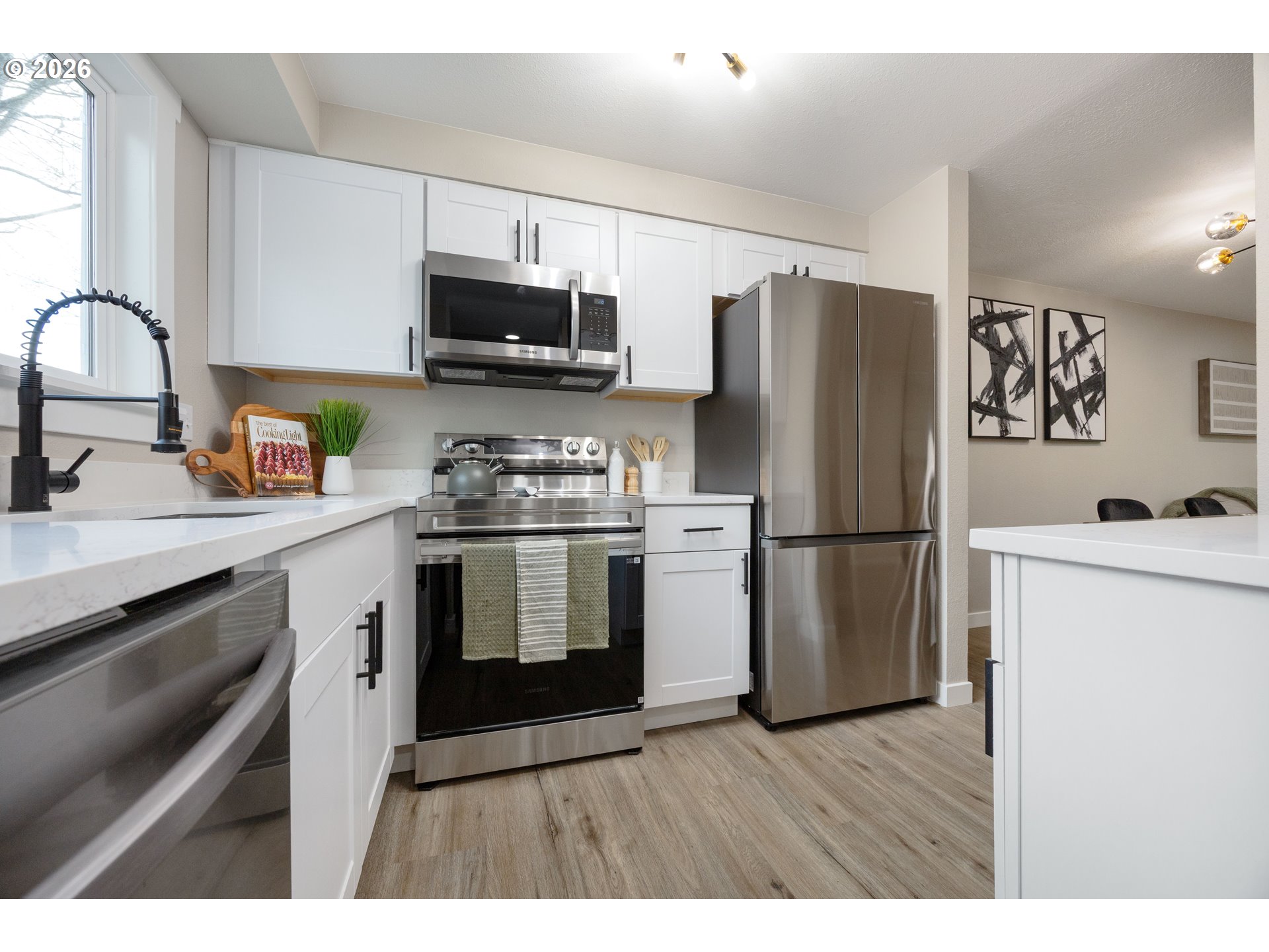 4921 Southwest 59th Avenue, Unit 6 Portland, OR 97221 - Photo 9 of 23 a kitchen with stainless steel appliances a refrigerator stove and sink